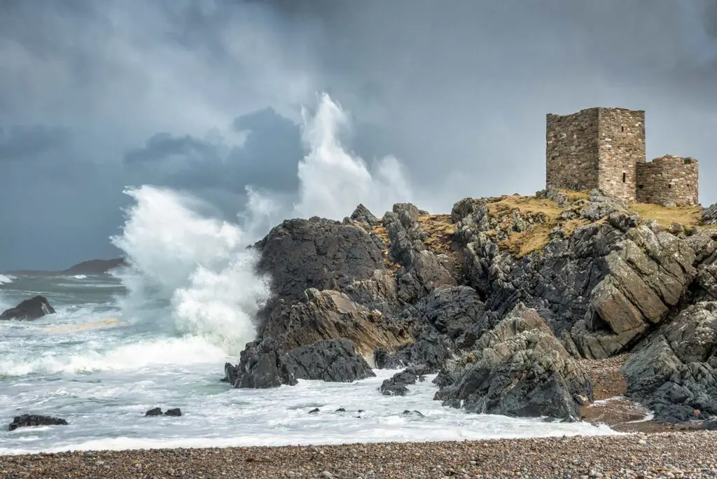 A storm at Carrickabraghy Castle with waves hitting the rocks