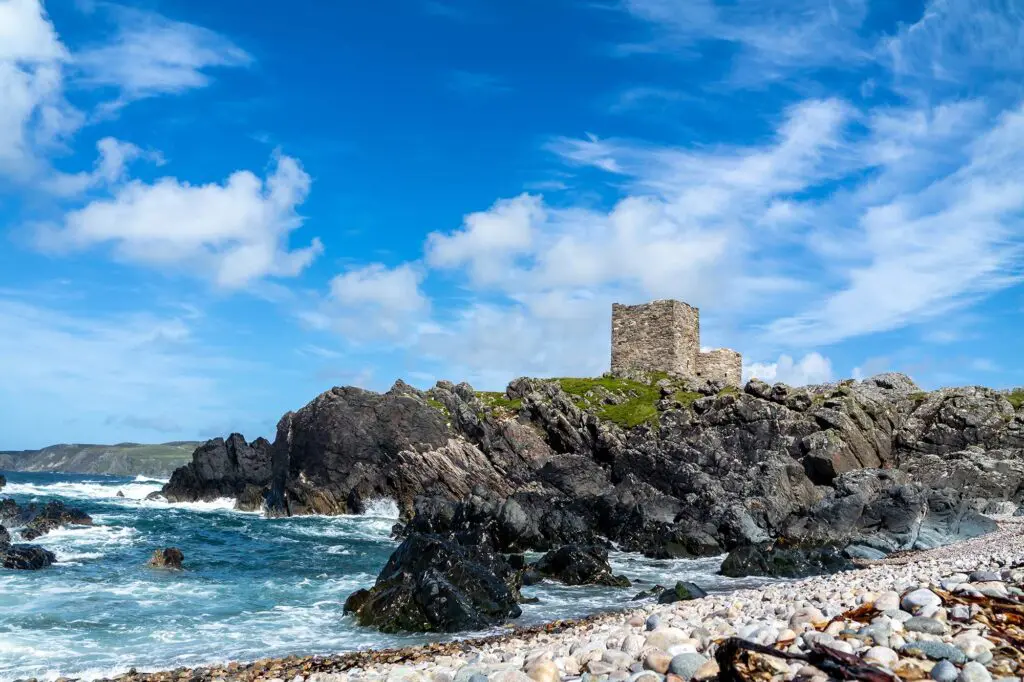 Carrickabraghy Castle on a rocky headland in the Atlantic Ocean