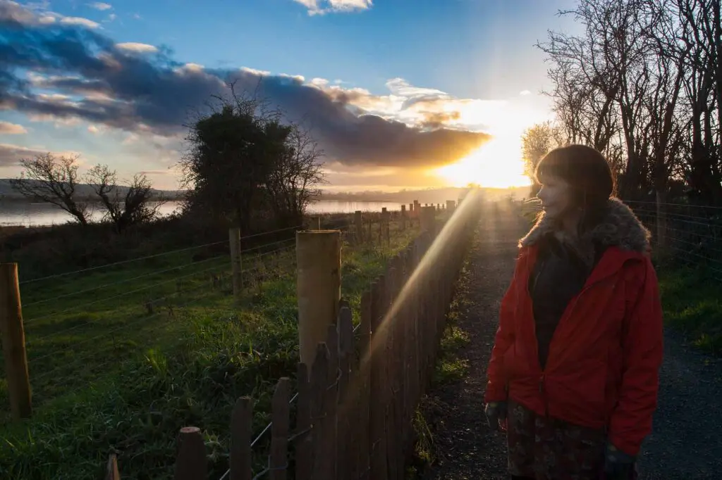Sunset at Inch Wildfowl Reserve with a woman looking out over the lagoon