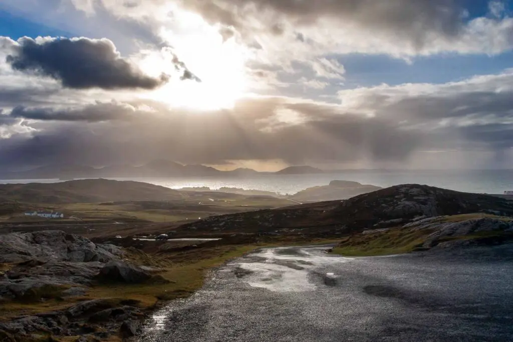 The dramatic view west from Banba's Crown with dark clouds and rays of sunshine